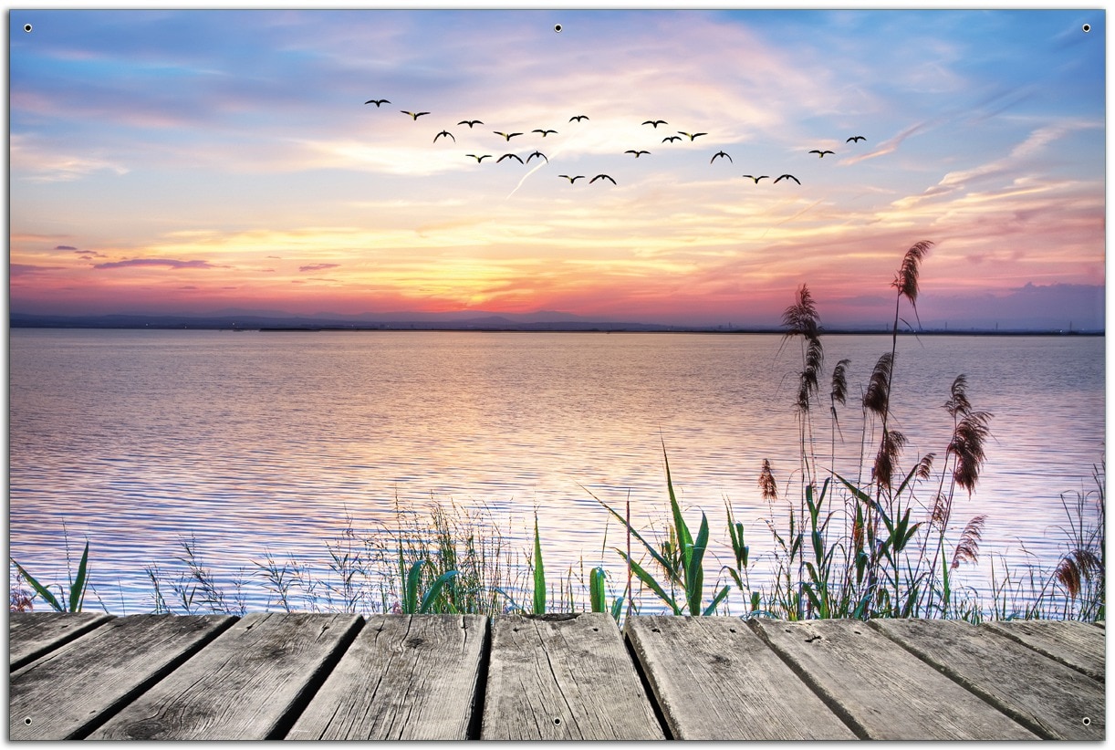 Wallario Gartenposter ca. 120 x 180 cm Seepanorama mit Schilf und fliegenden V&ouml;geln 