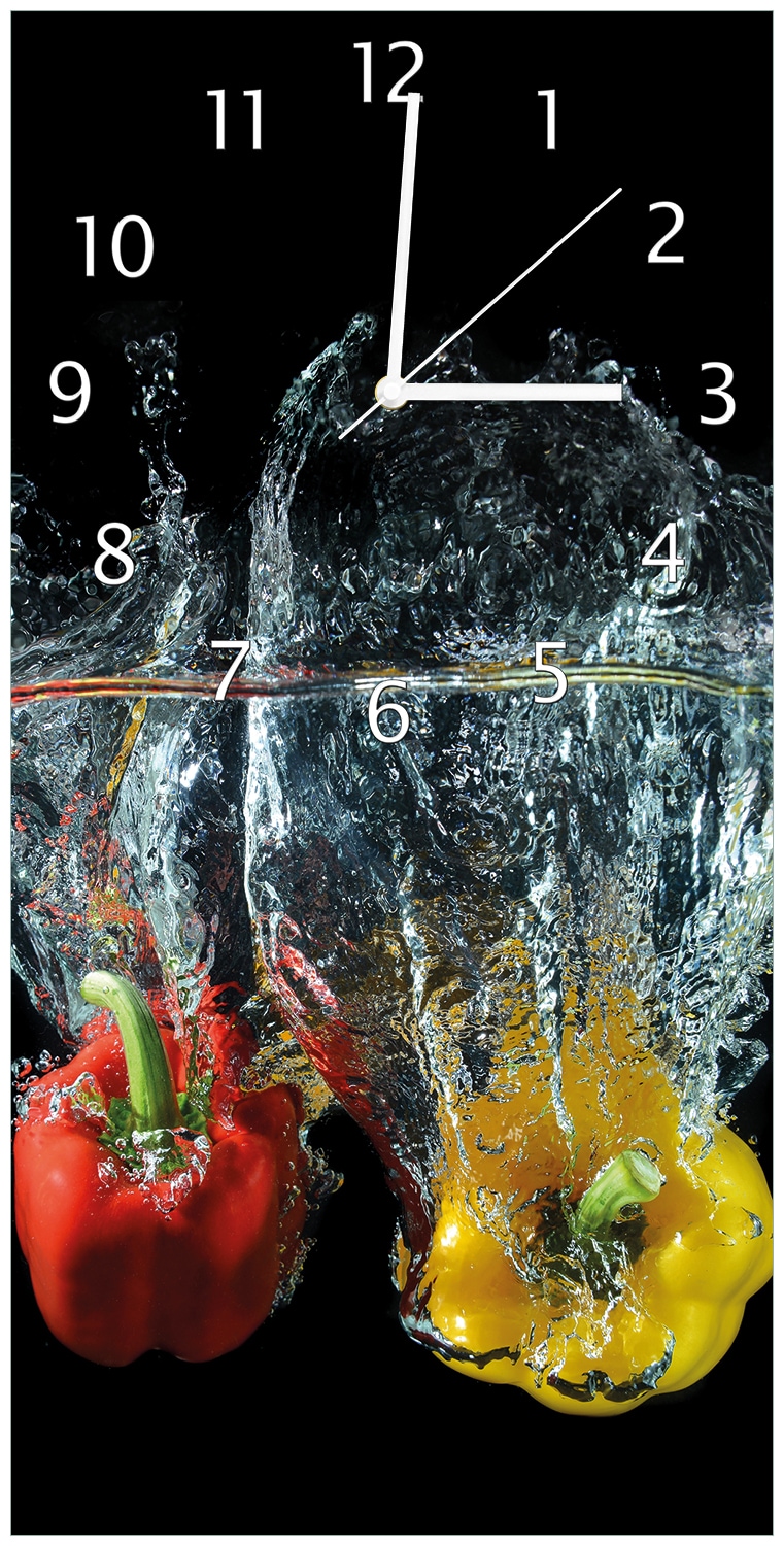 Wallario Uhr 30 x 60 cm, wei&szlig;e Zeiger Paprika-Mix - frische Paprika in rot, gelb und gr&uuml;n im Wasser 